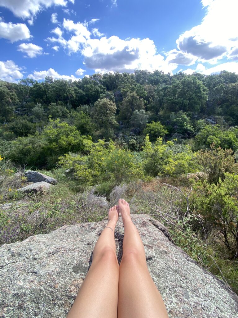 girl sitting on ancient stone in heart of catalonia .in the forest in spain