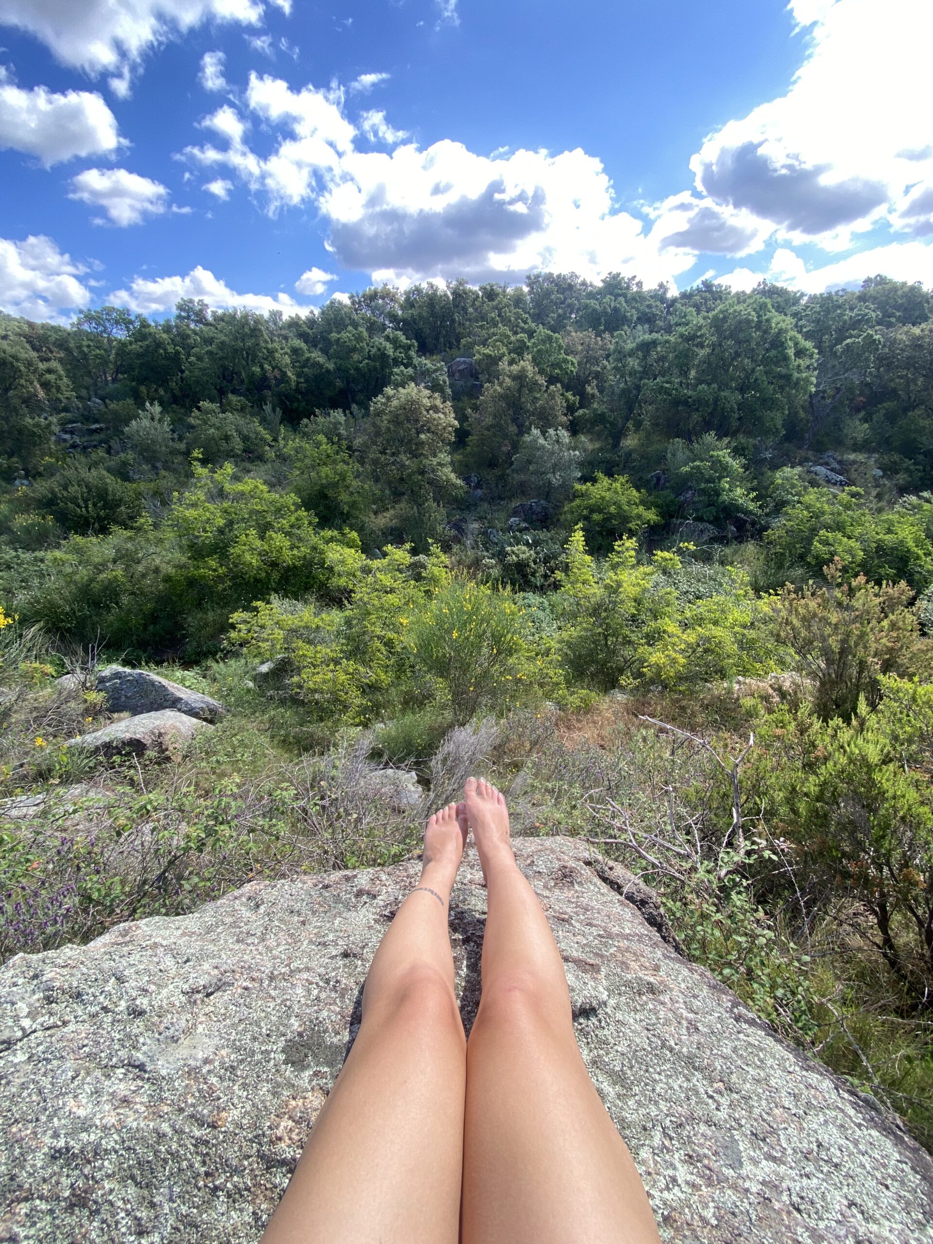 girl sitting on ancient stone in heart of catalonia .in the forest in spain